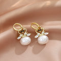 Gold Tone Swan Crystal Look Pearl Look Huggie Earrings view 4