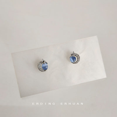Silver-tone star-moon clear-stone blue-round studs in the first product display.