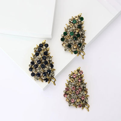 Front product view of the clustered crystal leaf brooch on a light background