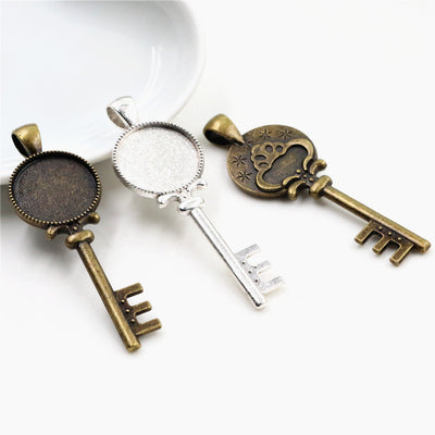 Mushroom Key Shaped Round Cabochon Pendant Bases in Two Finishes shown in a grouped front view