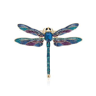 Blue Dragonfly, Green Dragonfly brooch styles arranged on a light display