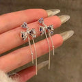 Silver Crystal Bow And Fine Chain Tassel Stud Earrings view 1