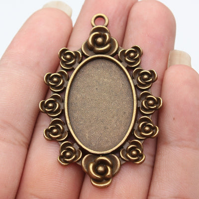 Front view of rose border oval cabochon pendant setting on fingertips