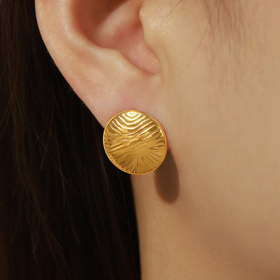 Model wearing gold round wave disc stud earring side view