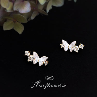 Gold-tone pearlescent-wing butterfly clear-stone studs in the first product display.