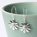 White Gold Daisy Flower Hook Earrings Textured Center Detail view 1
