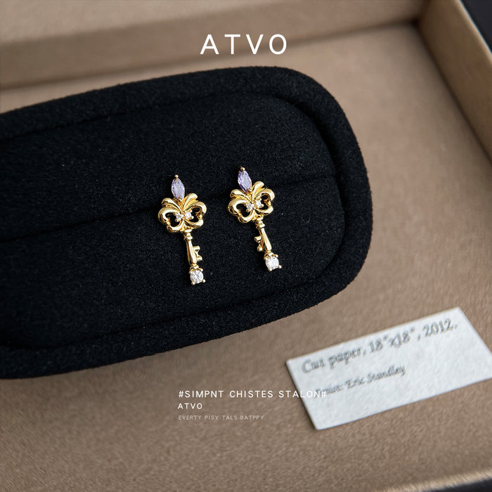 Gold Tone Iris Key Shape Purple And Clear Stone Stud Earrings