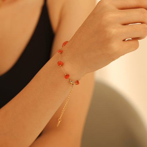 Gold coral pink natural stone bracelet on wrist side view