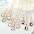 Gold Tone Crystal Teardrop Evil Eye Necklace and Earring Options view 1