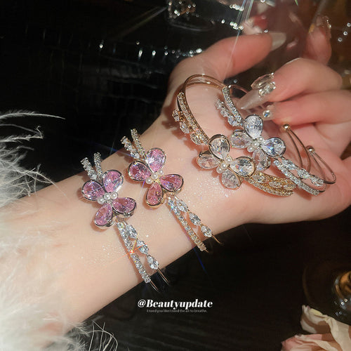 Pink and clear butterfly cuffs worn and held on wrist