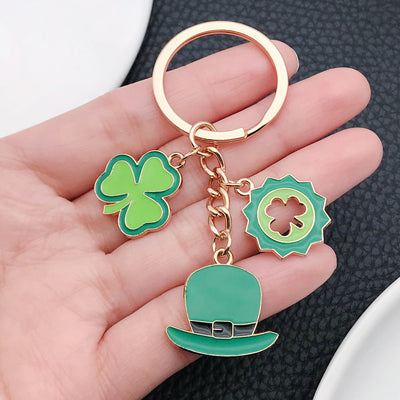 Main display of two green clover and hat theme keychains