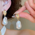 Gold Tone Baroque Pearl Drop Earrings With Polished Metal Details view 3
