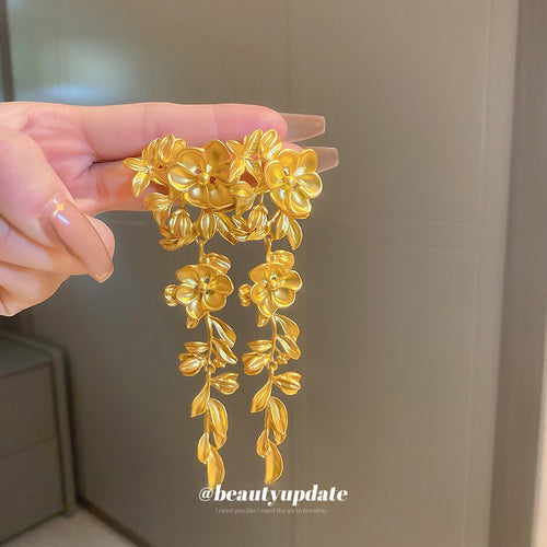 Product view of gold tone floral vine statement drop earrings statement jewelry
