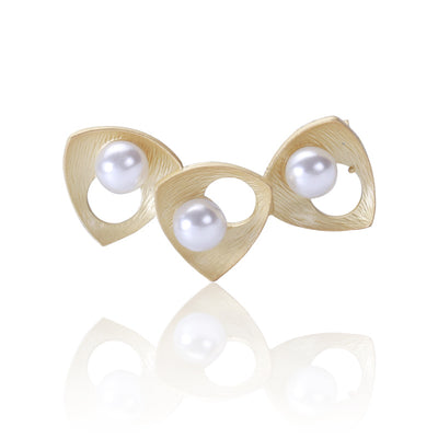 Front view of triple heart brooch with white pearl accents decorative metal pin
