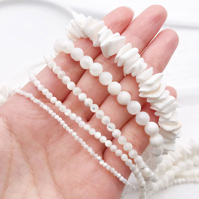 White shell beads arranged on a light background
