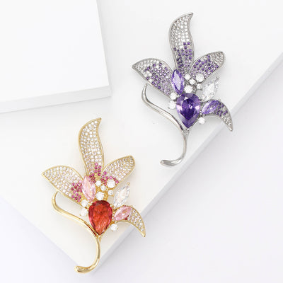 Front view of elegant crystal lily flower brooch in purple and pink
