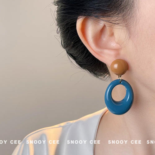 Caramel ball blue oval drop earring worn on ear side profile