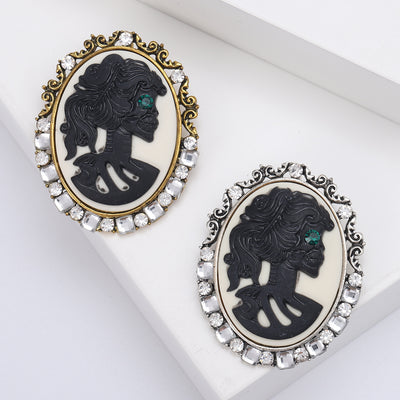 Front view of skeleton lady cameo brooch with crystal border decorative metal pin