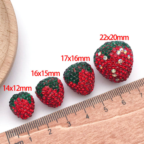 Styled close-up of red rhinestone strawberry clay bead showing colors and surface details