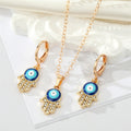 Gold Tone Crystal Hamsa Evil Eye Necklace and Huggie Earrings view 1
