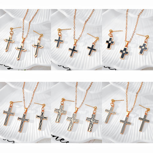 Grid of six gold black enamel cross necklace and earring jewelry sets
