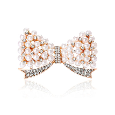 Rose Gold Bow, Silver Bow brooch styles arranged on a light display
