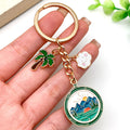 Four Green Camping Mountain and Palm Tree Metal Keychain Designs view 3
