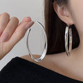 Polished Elongated Oval Hoop Earrings in Gold and Silver view 3