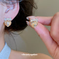 Gold Tone Crystal Heart Stud Earrings with Bow Details view 3
