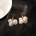 Four White Petal Flower Bead Hook and Clip Earrings view 4