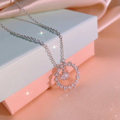 Silver open heart CZ pendant necklace on pastel gift boxes