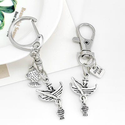 Antique silver charm keychains with fish and boat designs