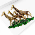 Three Giraffes Enamel Brooch Walking Across Green Grass view 3