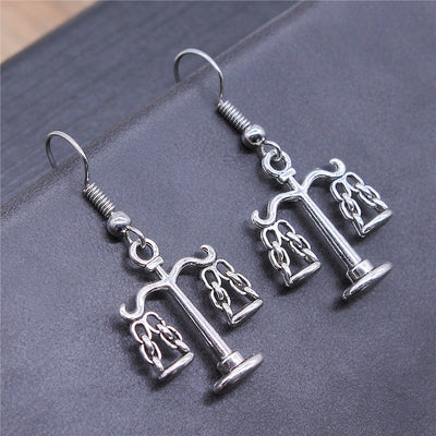 Balance Scale Dangle Earrings in Silver and Bronze Tones shown in image 1 with balance-scale charms on fishhook ear wire