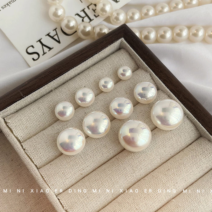 White Pearlescent Round Stud Earrings In Five Graduated Sizes