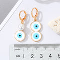 Gold Tone Asymmetric Pearl and Evil Eye Huggie Drop Earrings view 2