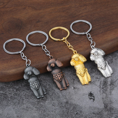 Five metal poodle keychains in assorted finishes