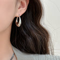 Polished Teardrop Hoop Earrings in Gold and Silver view 4