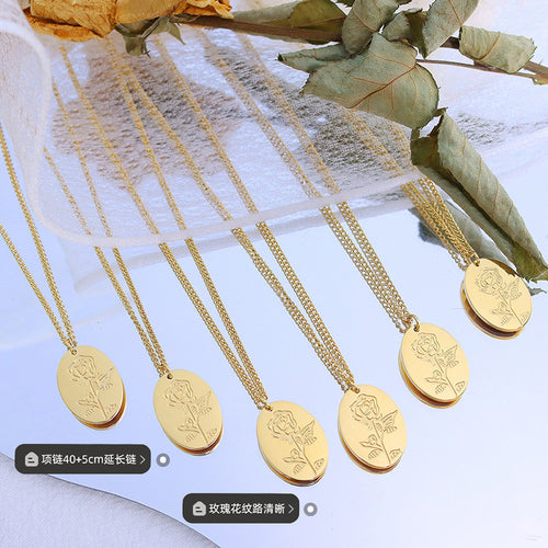 Five gold oval rose pendants on curb chains with dried flowers and labels