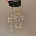 Open Cross Hoop Earrings in Gold and Silver with Polished Metal Details view 8