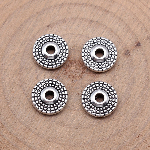 Dotted Round Wheel Spacer Beads in Two Antique Metal Finishes shown in image 2, highlighting concentric dotted rings and