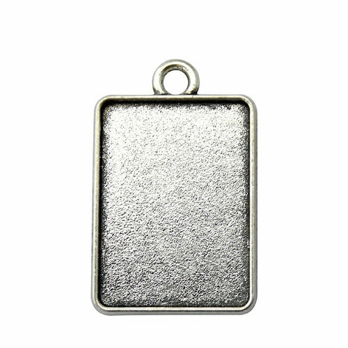 Textured Rectangular Cabochon Settings in Two Finishes arranged on a wood slice