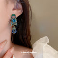Blue Crystal Oval Statement Clip On Earrings with Polished Metal Accents view 3