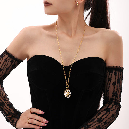 Model front view white enamel snowflake pendant gold paperclip necklace