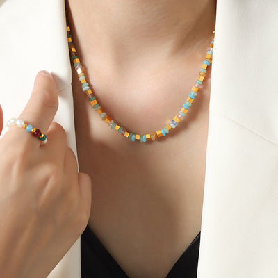Multicolor gold cube beaded necklace worn on neck
