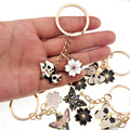 Gold Tone Butterfly Skull and Sakura Flower Clip Keychains view 2