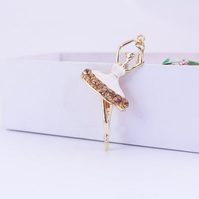 White enamel ballerina charm with brown rhinestones along the tutu.