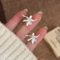Sculptural Lily Flower Metal Stud Earrings With Decorative Metal Accents view 6