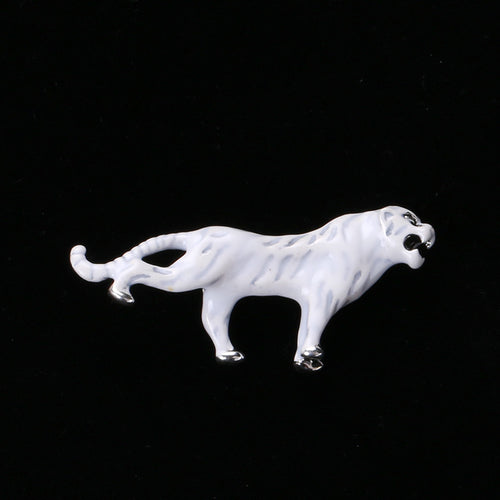 Angled display of the striped enamel tiger brooch on a white surface