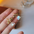 Gold-Tone Bow Clear Crystal Bell Drop Hook Earrings Pair view 1